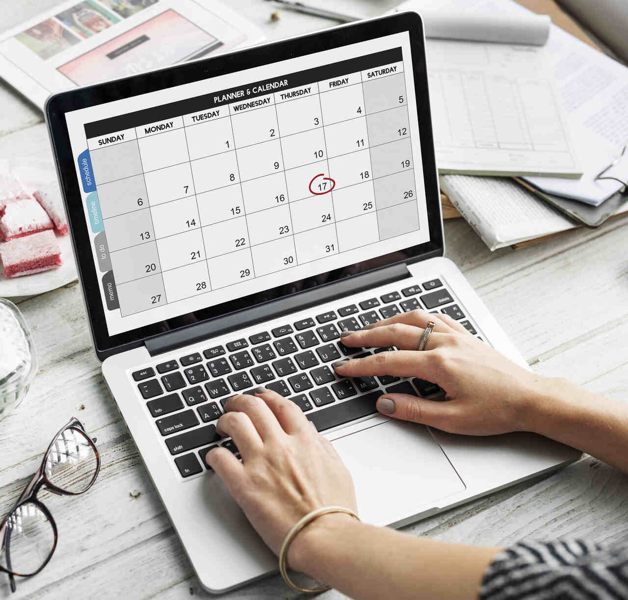 Pessoa verifica calendário no notebook